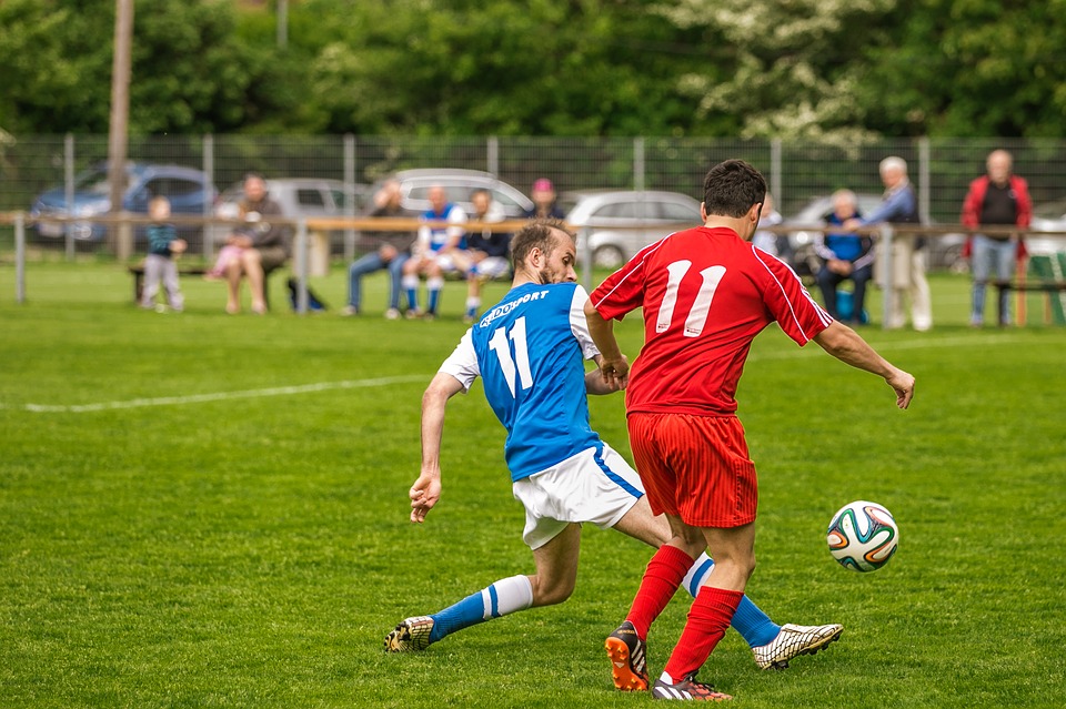 two football players fighting for the ball